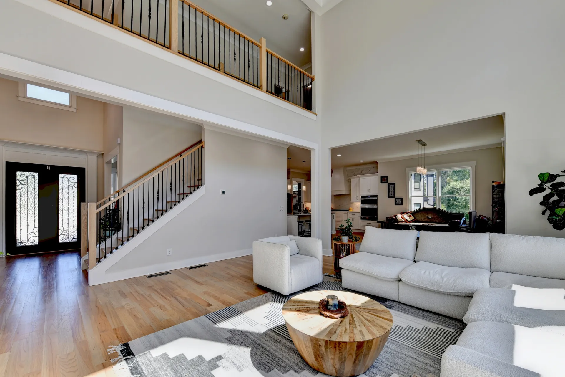 Two-story great room with tall windows and open staircase